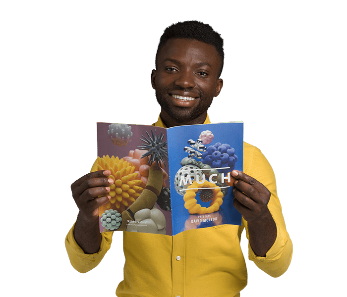 Man holding mini-sized newspaper.